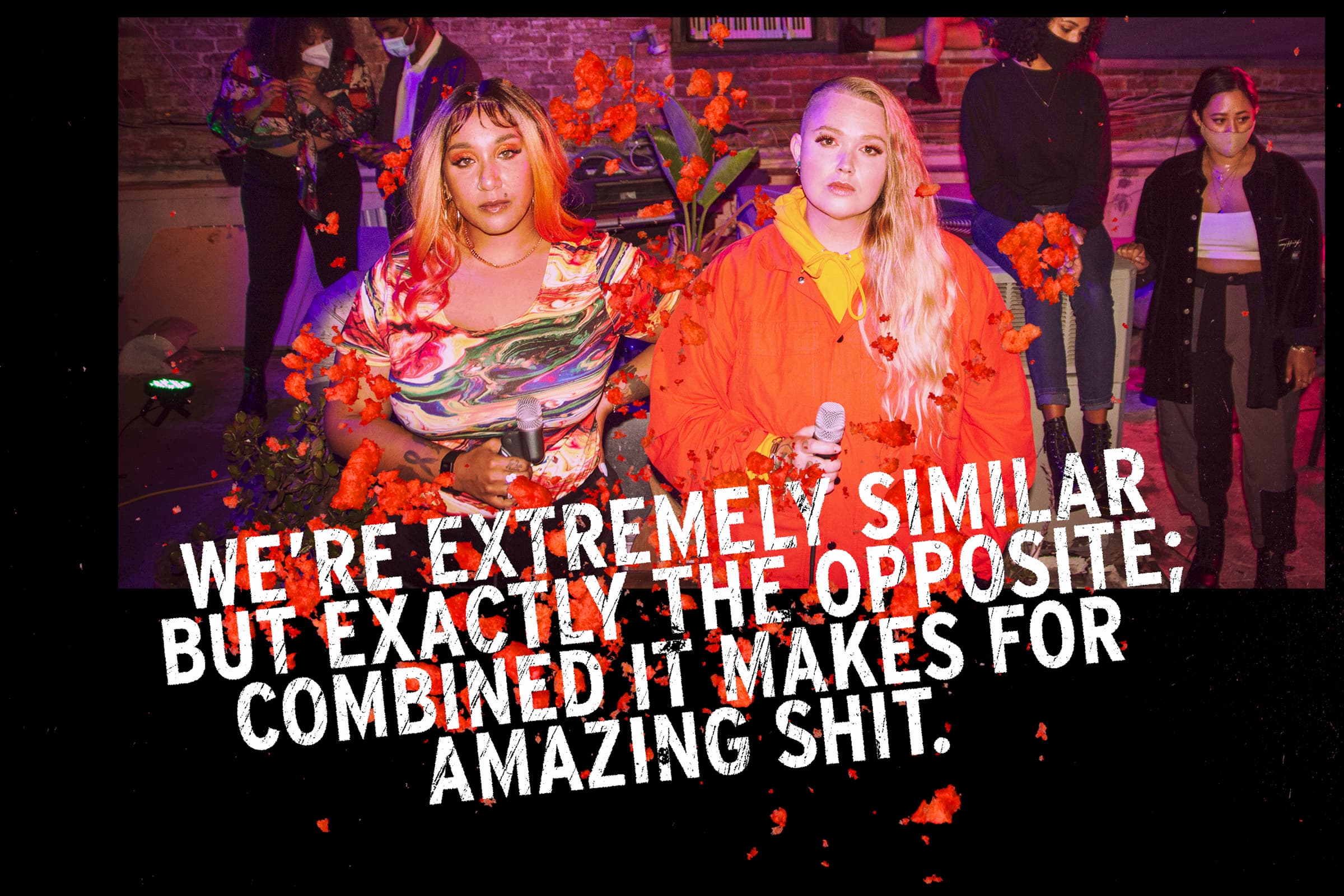 A photo of Blimes & Gab looking directly into the camera with a confident look, they are holding microphones and are at an event. Overlaid are the words "We're extremely similar but exactly the opposite; combined it makes for amazing shit."
